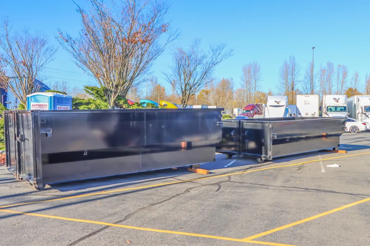Professional dumpster rental service with roll-off container on residential driveway in Jupiter Farms
